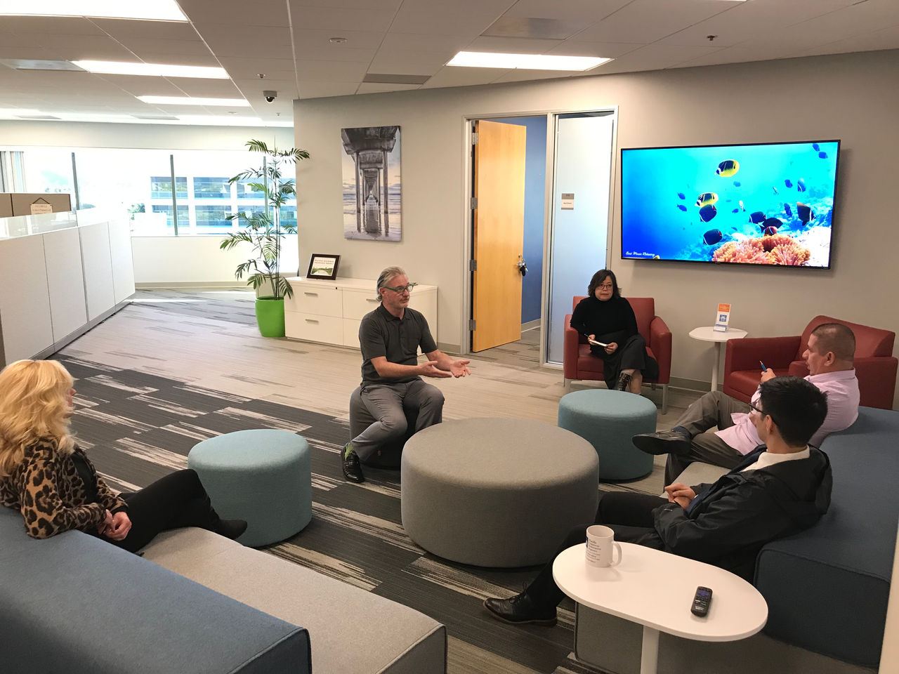 PGIA Employees talking in the office