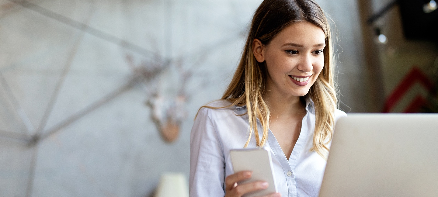Smiling woman working on a laptop
