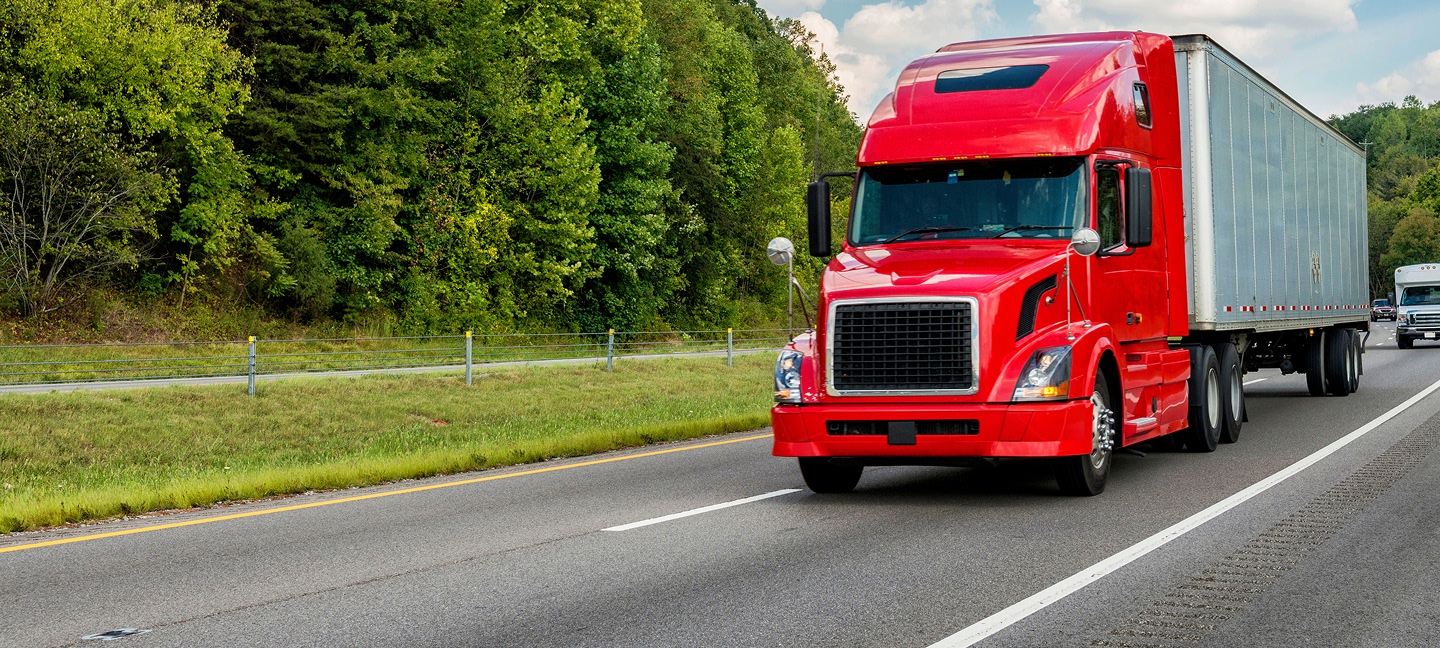 Red truck driving on interstate