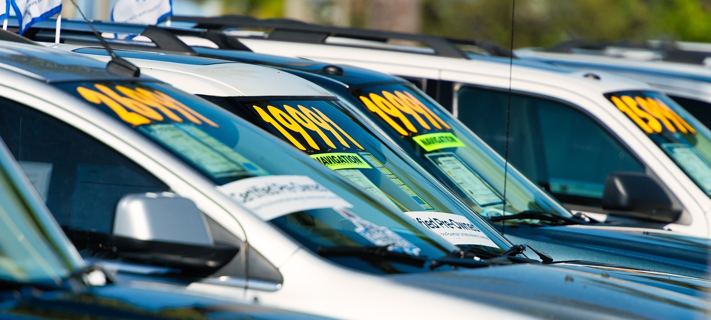 Row of SUVs with prices on them at dealership