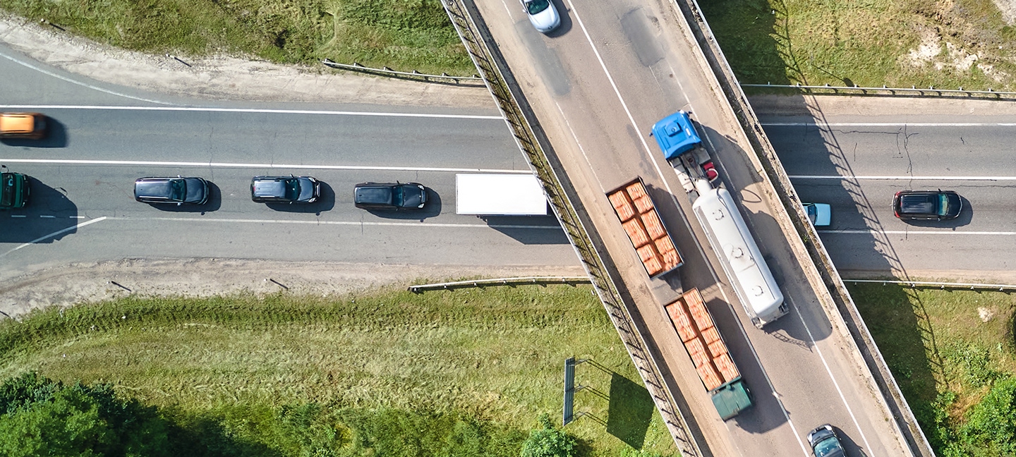 Aerial view of trucks going over a bridge over an interstate